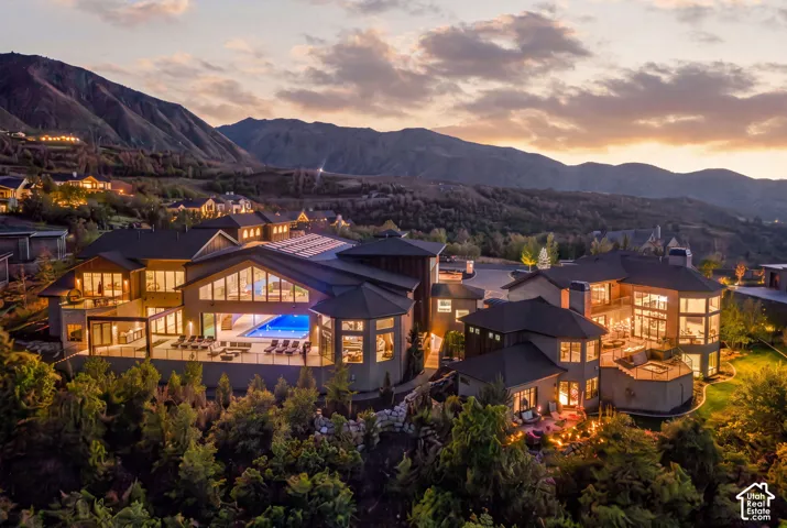 Spacious multi-level residence with extensive outdoor decking, large windows, and an indoor swimming pool