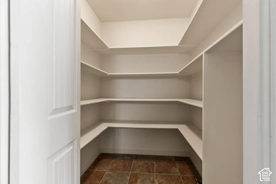 Built-in shelving, white painted finishes, tiled flooring, paneled door