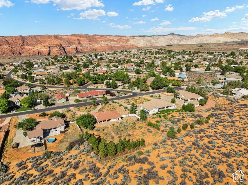 Expansive desert landscape featuring residential development and prominent rock formations