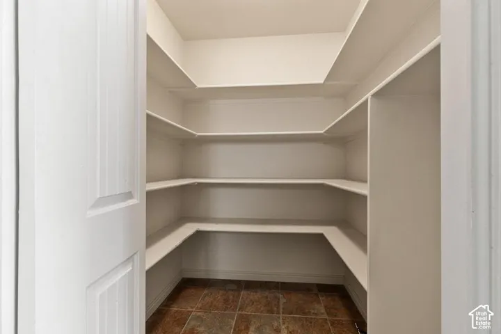 Built-in shelving, white painted finishes, tiled flooring, paneled door