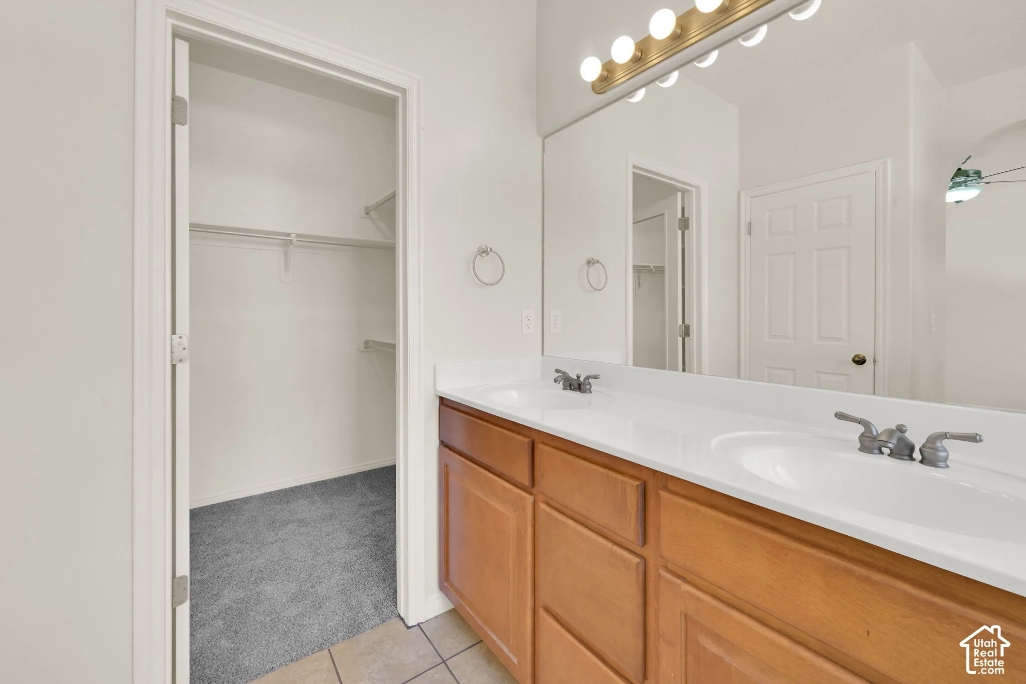 Dual sinks and walk-in closet in primary bathroom.