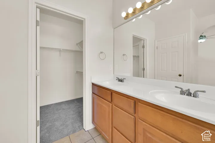Dual sinks and walk-in closet in primary bathroom.