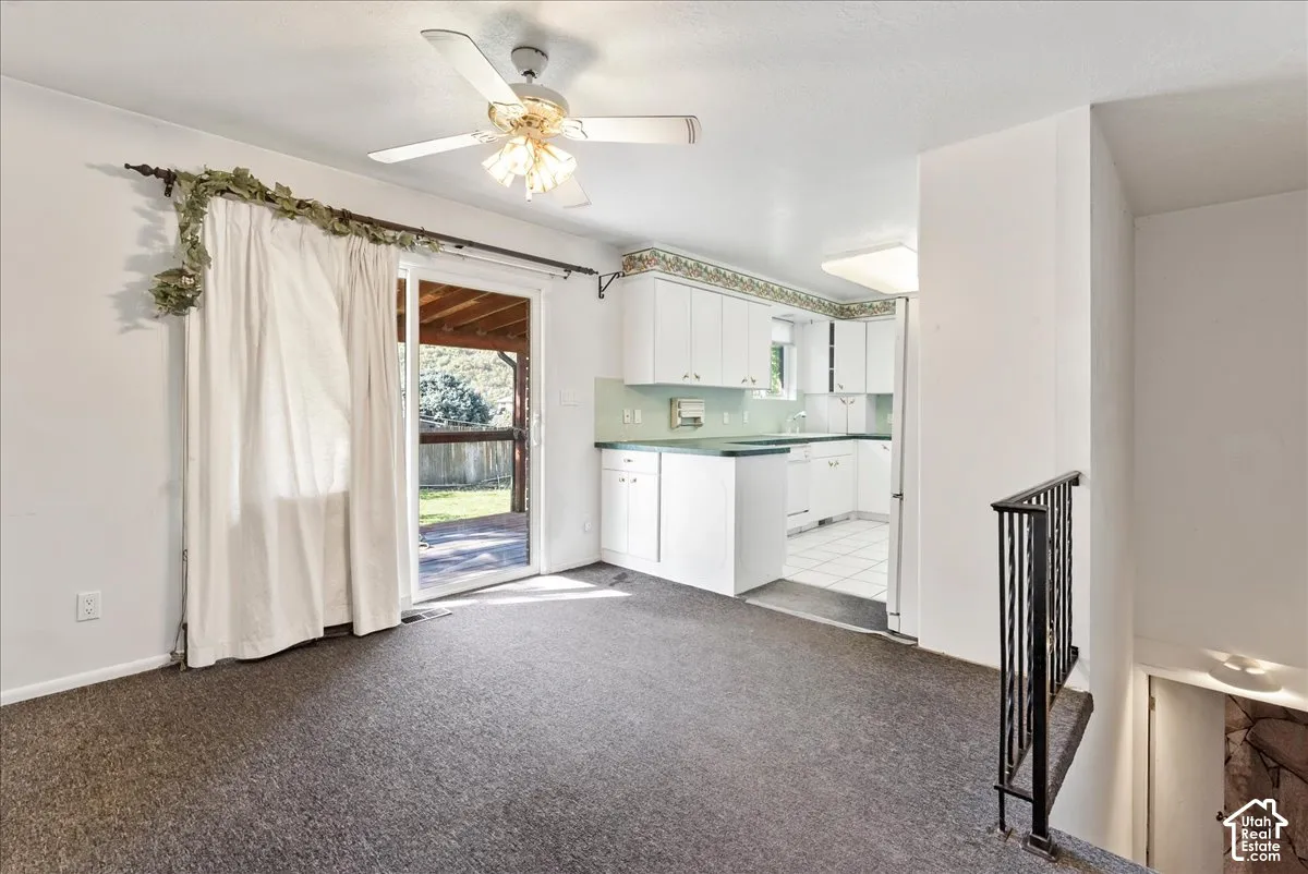 Kitchen featuring white cabinetry and light green countertops