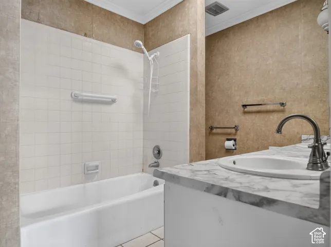 White subway tile bathtub surround, white porcelain bathtub, and an integrated white porcelain sink