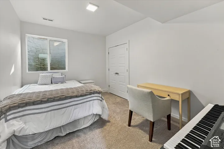 Carpeted flooring, white walls, and a window with white trim
