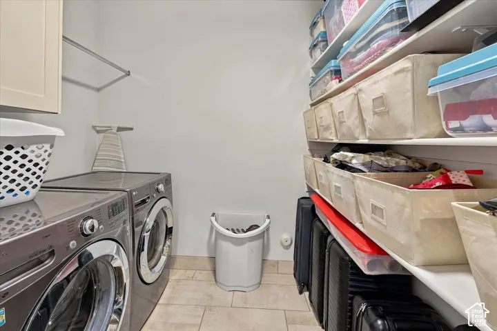Built-in shelving for storage, upper cabinetry, and a clothing rod