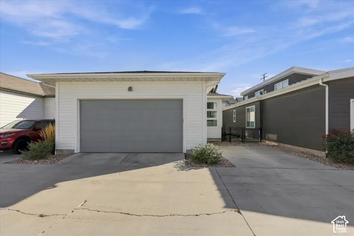 Attached single-car garage with a gray panel door