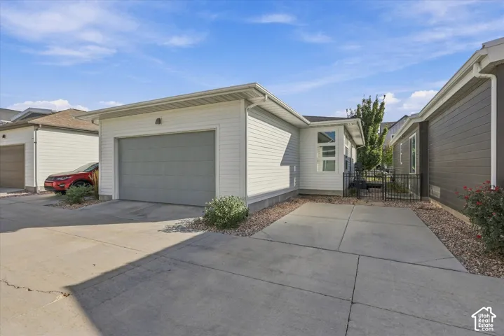 Attached single-car garage with a gray door