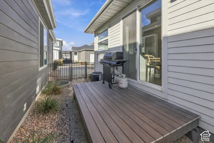 Deck with wood-finish surface, sliding glass door, and gravel landscaping
