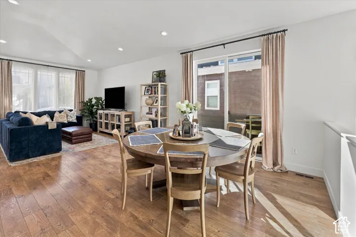 Wood-finish flooring throughout, recessed lighting, and a sliding glass door