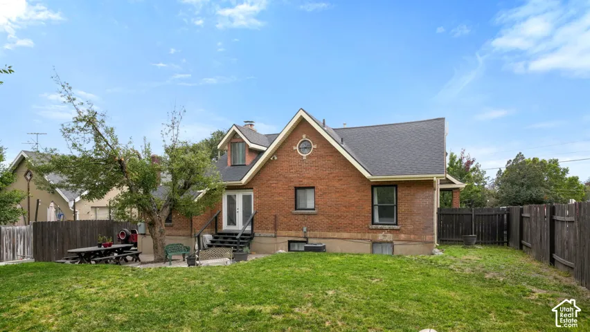 Brick exterior with a gabled roofline, dormer window, and a circular accent window