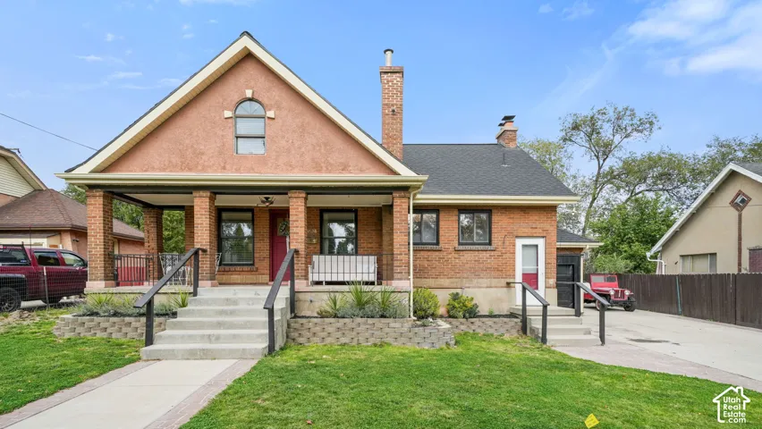 Brick and stucco exterior with a prominent front porch
