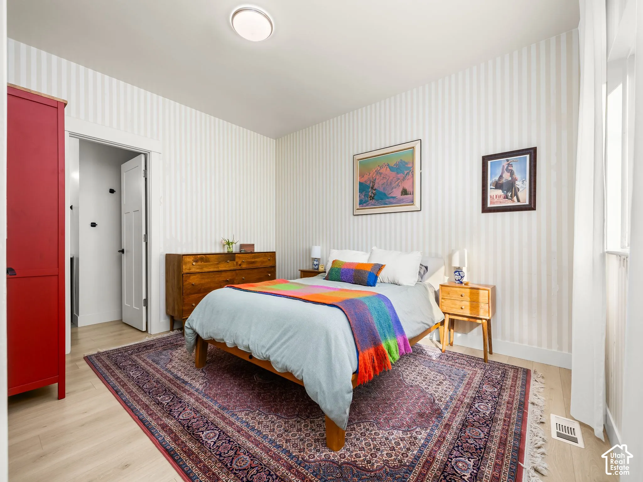Light wood-finish flooring with a flush-mounted ceiling light fixture