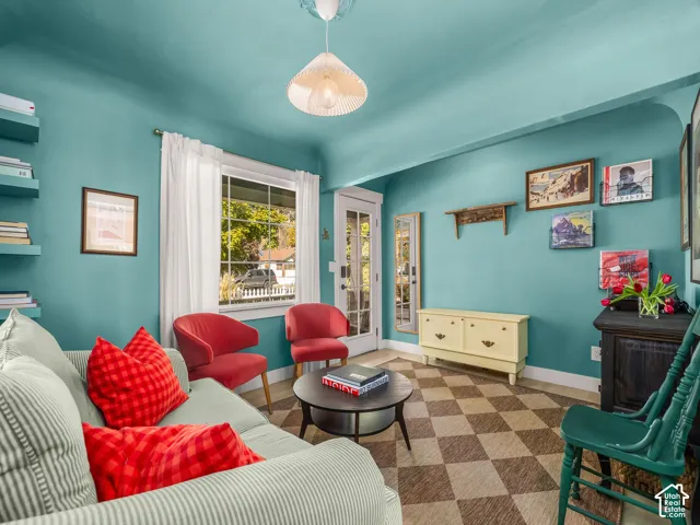 Vibrant living space with checkered flooring, built-in shelving, and a glass-paned door