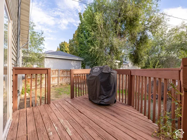 Wooden deck with matching railings and a sliding glass door