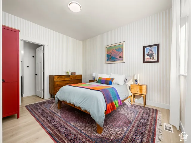 Light wood-finish flooring with a flush-mounted ceiling light fixture