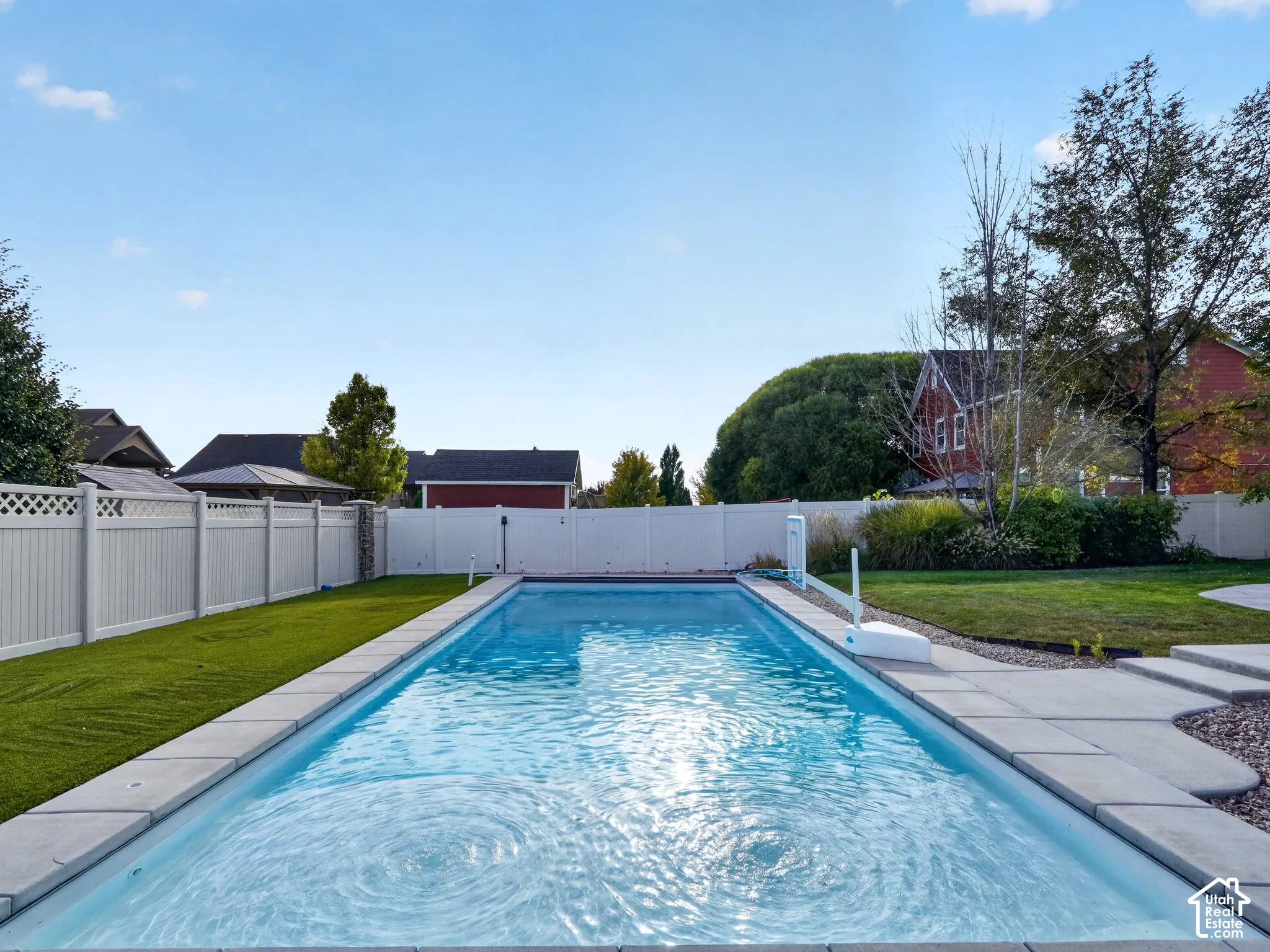 Rectangular in-ground swimming pool with surrounding concrete coping