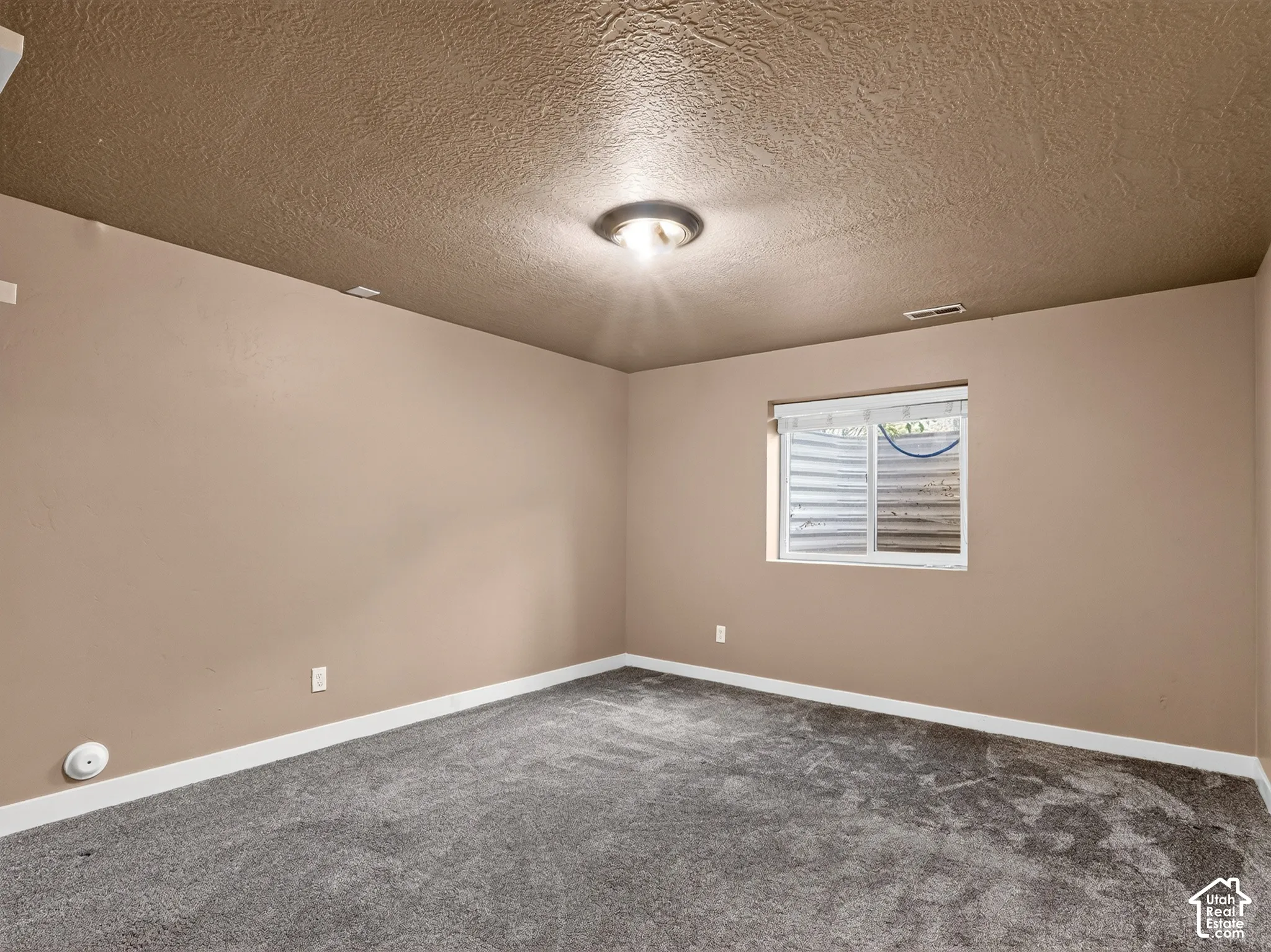 Neutral-toned walls complement the textured ceiling