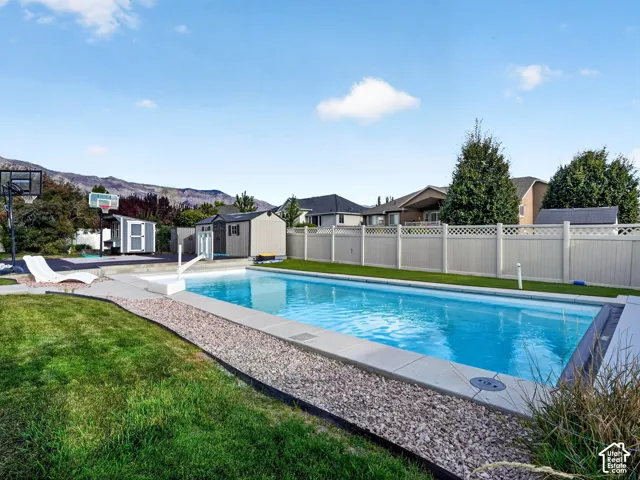 In-ground swimming pool with concrete surround