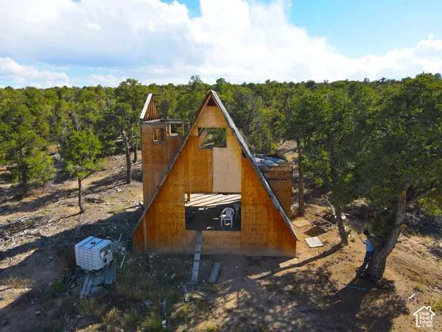 A-frame structure under construction with wood paneling