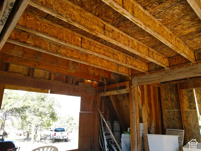 Exposed wood beam construction with oriented strand board ceiling