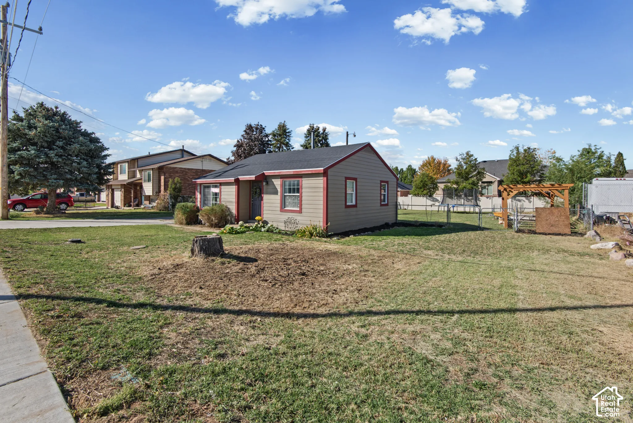Single-story residence with a gabled roof and light-colored siding