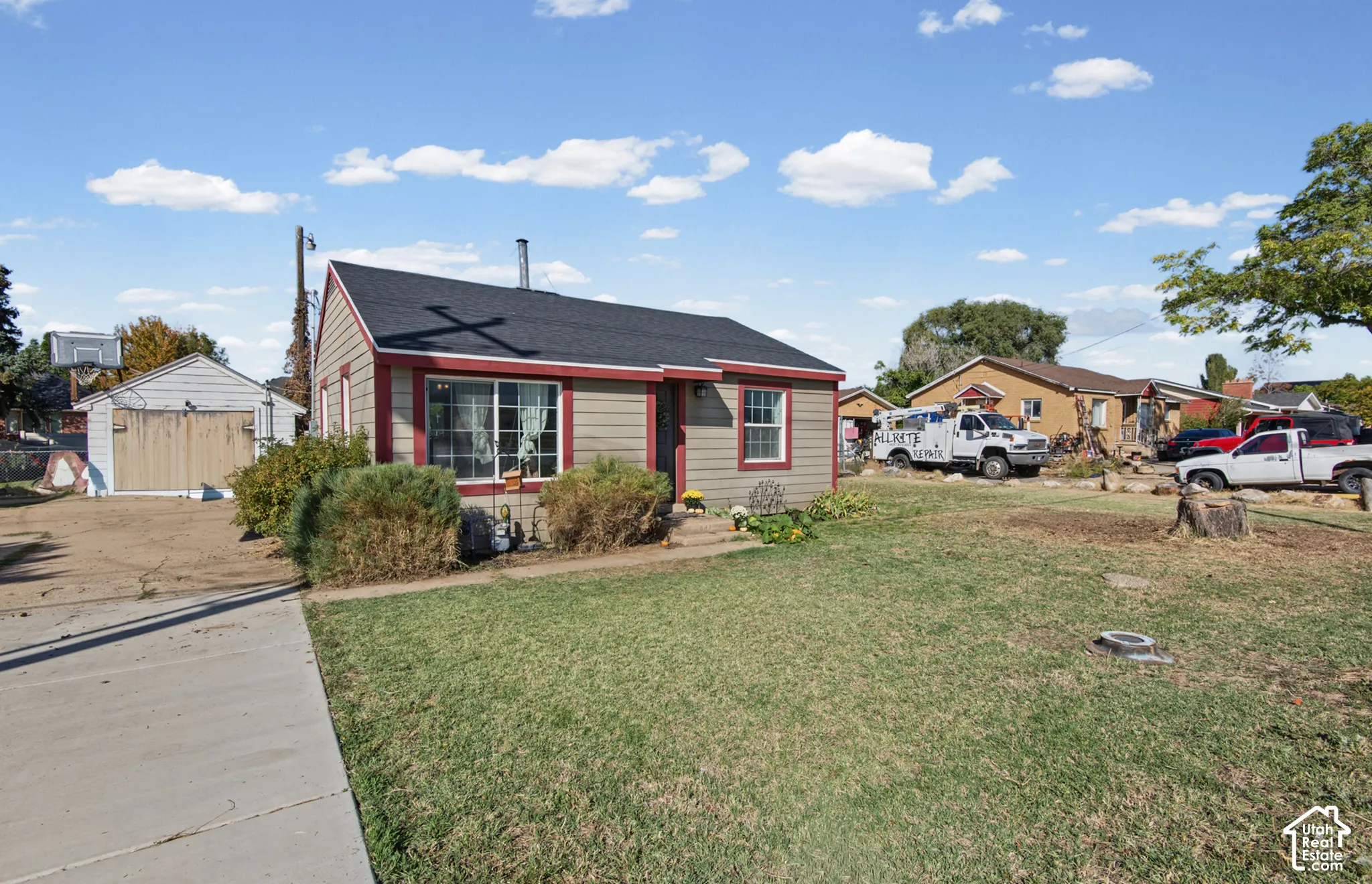 Single-story residence with siding exterior, contrasting trim, and a dark shingle roof