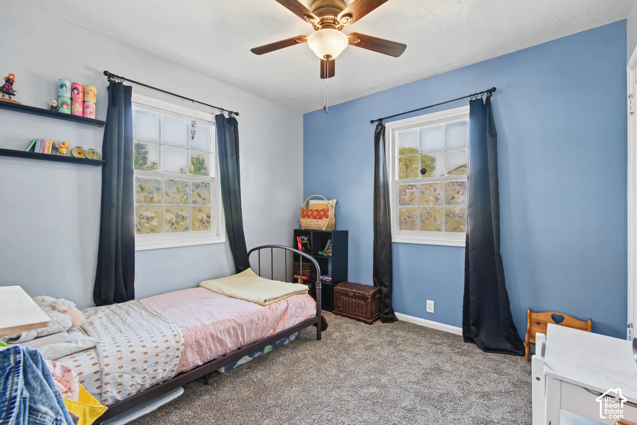 Recessed lighting, ceiling fan, two windows, and dark carpet flooring