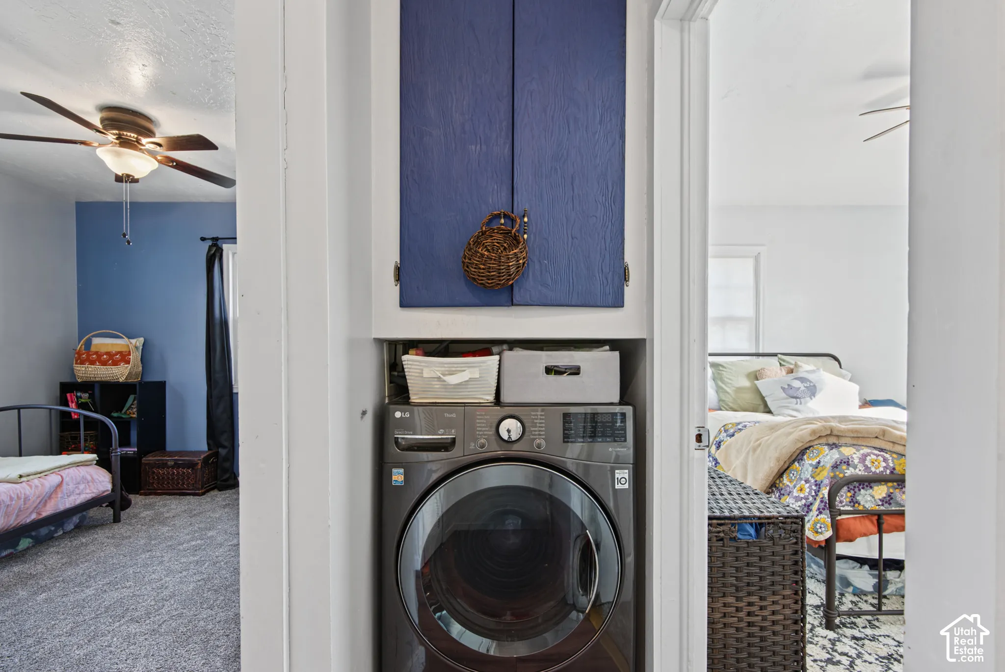 Built-in stacked laundry area with front-loading washer and integrated upper cabinetry