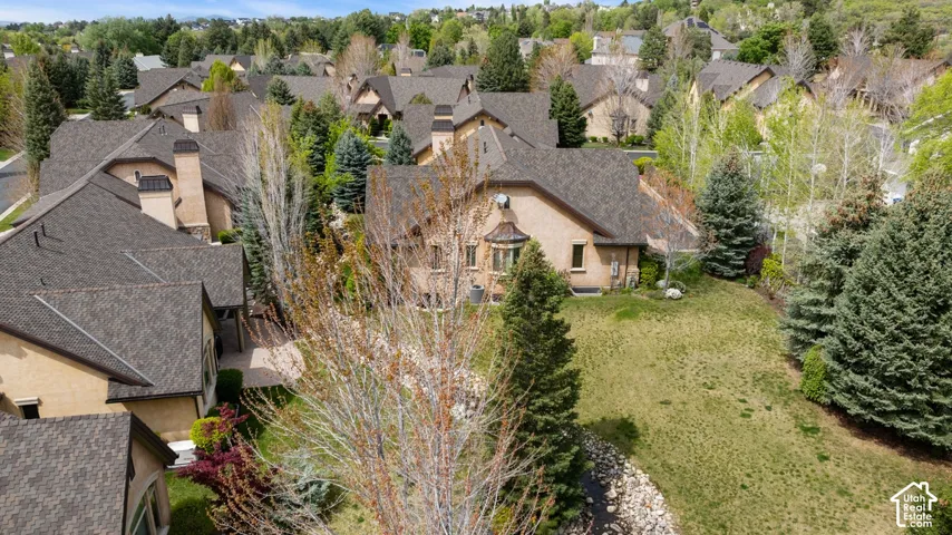 Residential property featuring a shingle roof and a stucco exterior