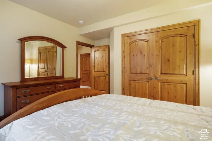 Arch-top wood doors, recessed ceiling lighting, and light-toned wall finishes