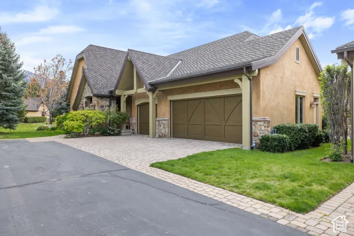 Stucco and stone exterior with a multi-gabled roofline