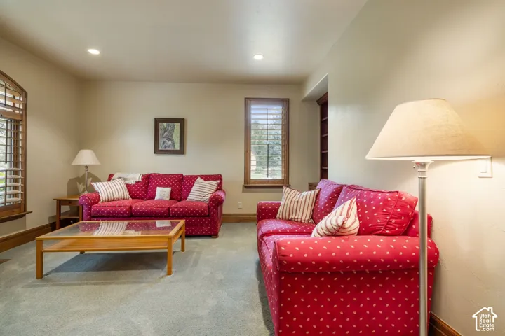 Recessed lighting illuminates neutral-toned walls and plush carpeting