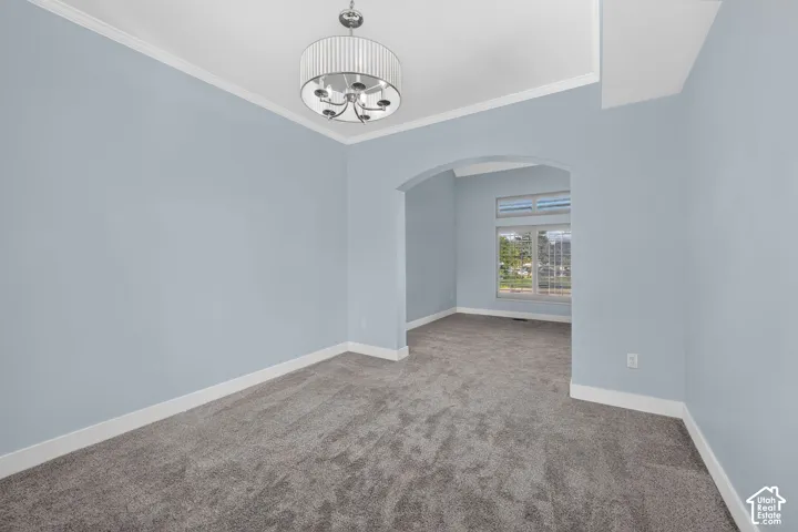 Recessed lighting, arched doorway, and gray carpet flooring