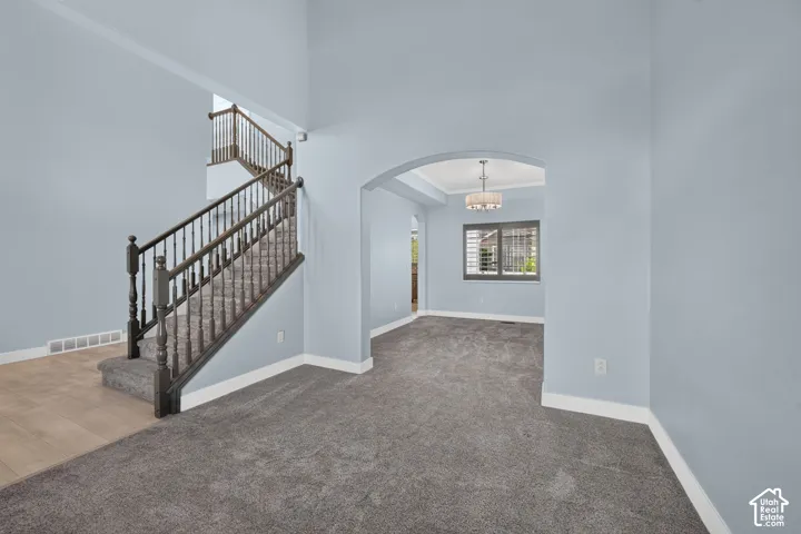 Two-story entry with a dark wood-finish staircase