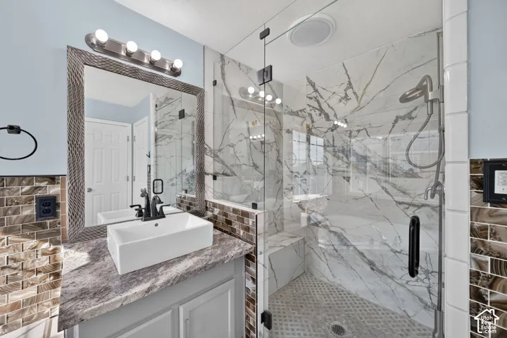 Walk-in shower with clear glass enclosure and built-in bench