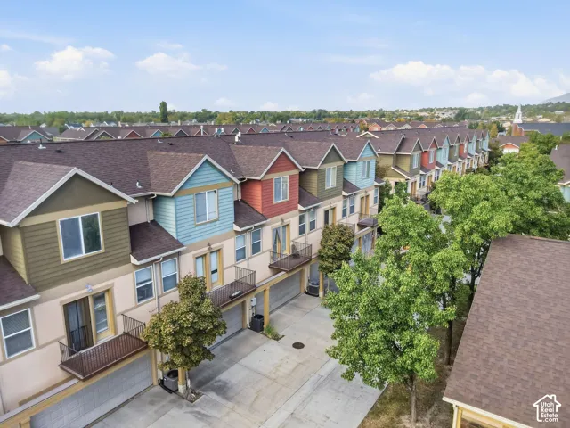 Townhome residences featuring varied exterior siding, private balconies, and individual garage access