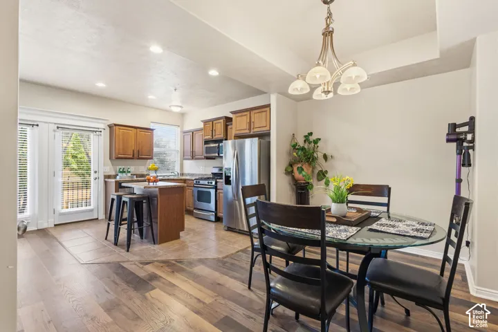 Kitchen with wood-finish flooring, recessed lighting, and a kitchen island