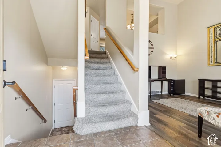 Staircase going upstiars to more living space and staircase going down to large two car garage.
