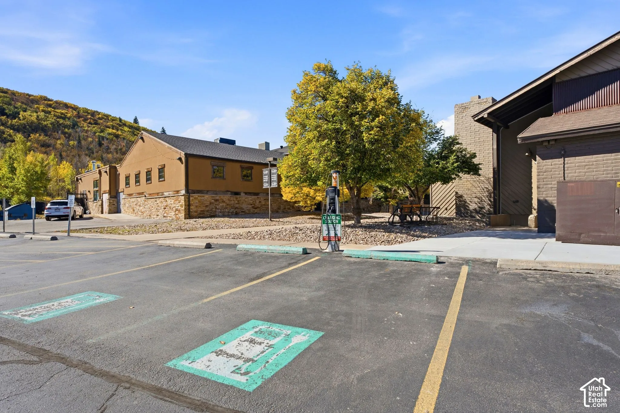 Paved parking area with marked spaces and an EV charging station