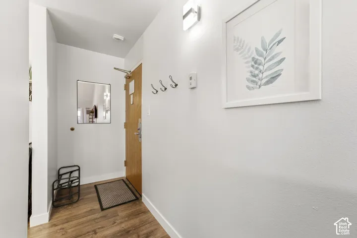 Wood-finish flooring with white baseboards