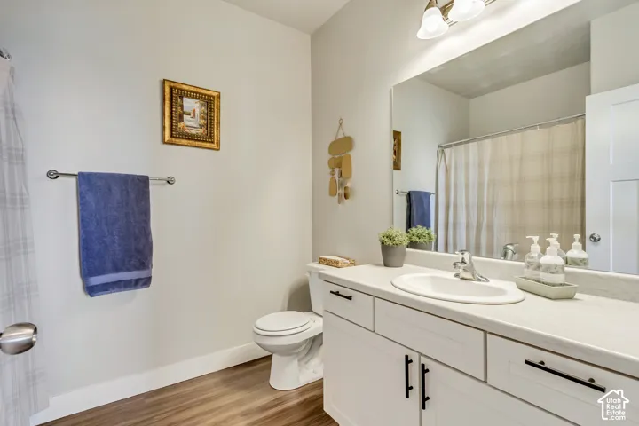 Wood-finish flooring with white baseboards
