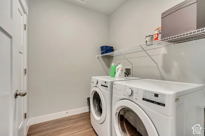 Wood-finish flooring, white trim, and light gray walls