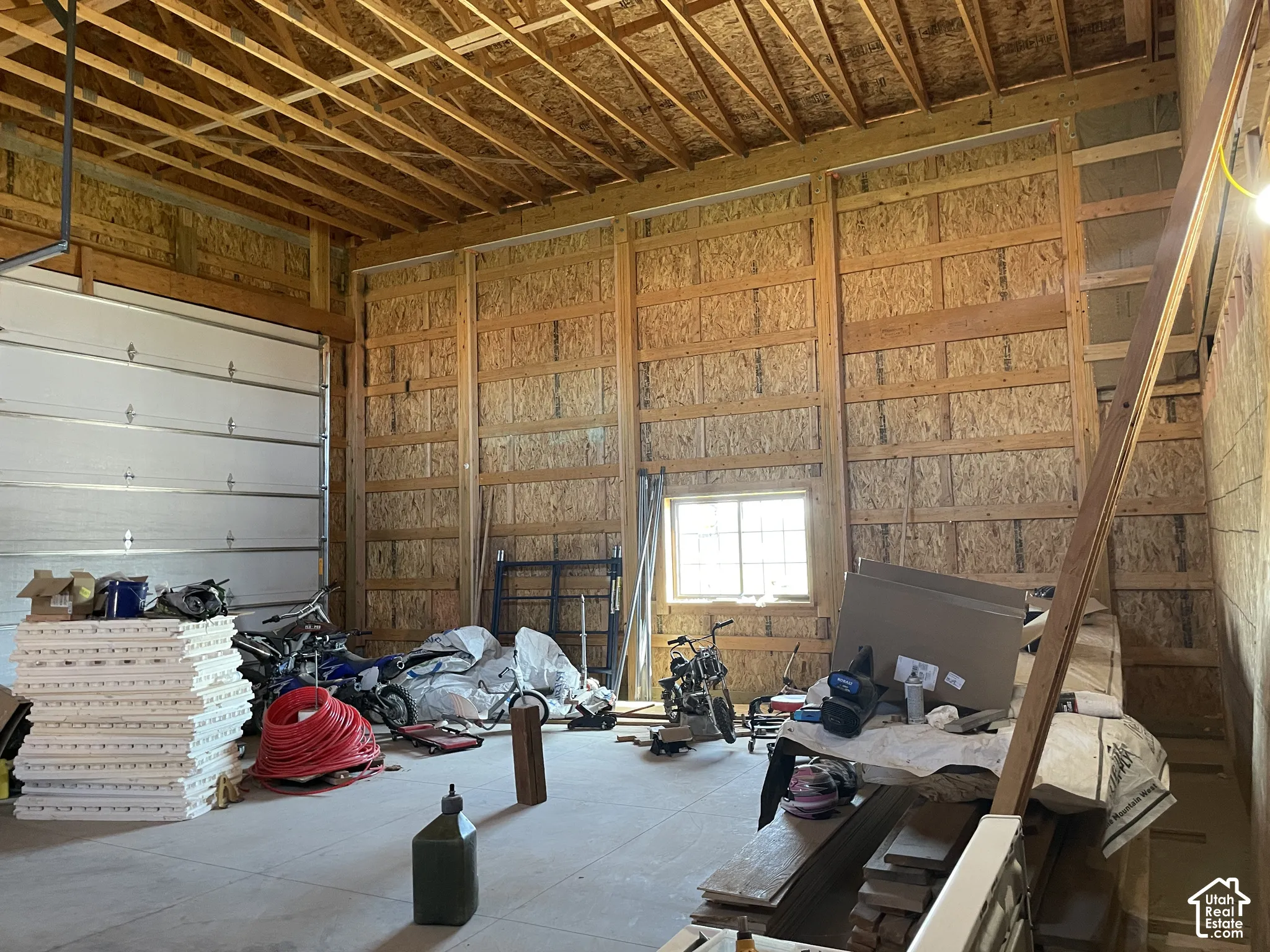 Extra height garage featuring reinforced floor for future 2-post car lift and heated floors
