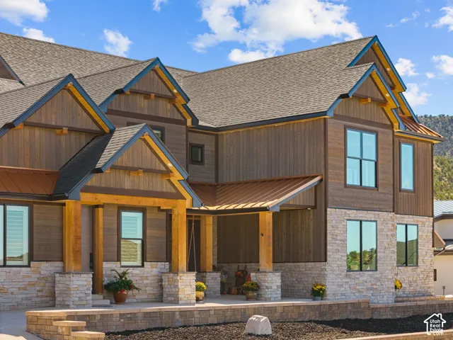 Multi-level exterior featuring natural stone and wood paneling