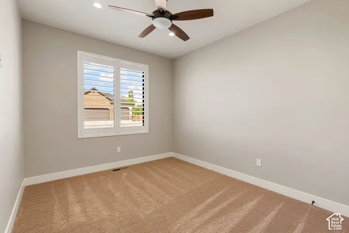 Recessed lighting, ceiling fan with light fixture, window with plantation shutters, and light-toned wall paint