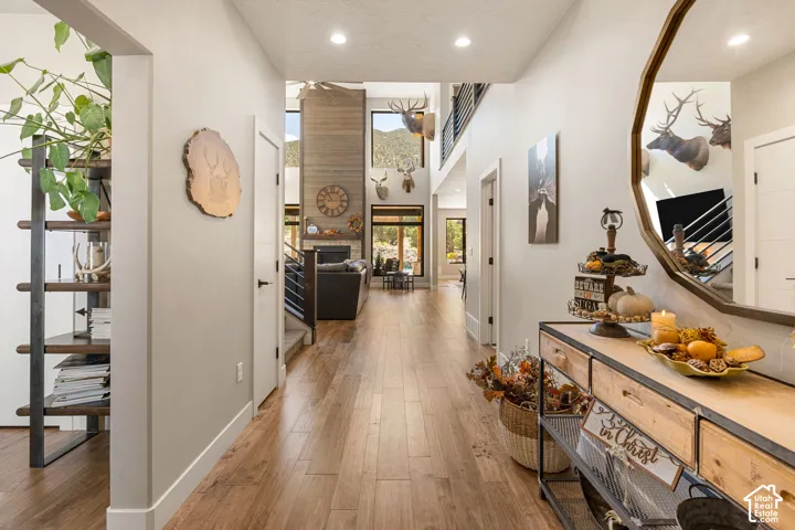Wood-finish flooring throughout, recessed lighting, and a prominent floor-to-ceiling accent wall