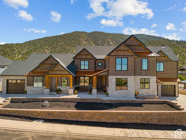 Craftsman-inspired exterior featuring board and batten siding and stone accents
