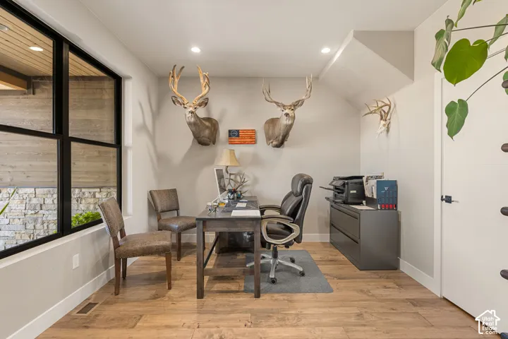 Wood-finish flooring, recessed lighting, and a large multi-pane window