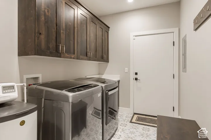Dark wood-finish cabinetry, patterned floor tiling, white countertop, and recessed lighting